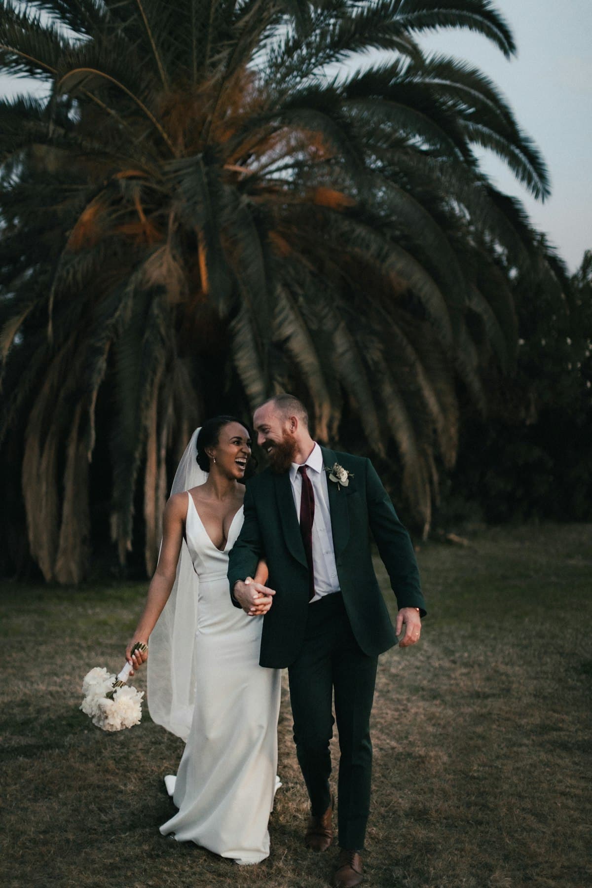 Couple walking through golden light — the cinematic feel an animated wedding invitation should capture