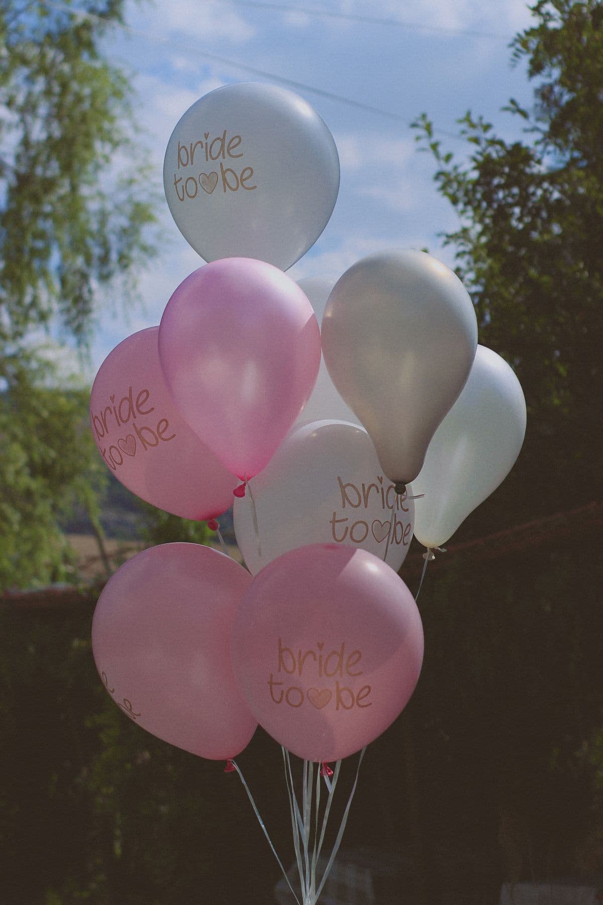 Pink and white bride-to-be balloons and party decorations for an online bridal shower invitation