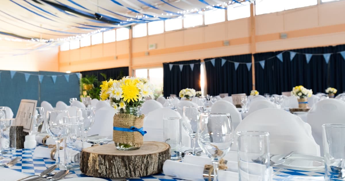 Elegant multi event wedding invitation dinner table with candles and floral arrangements