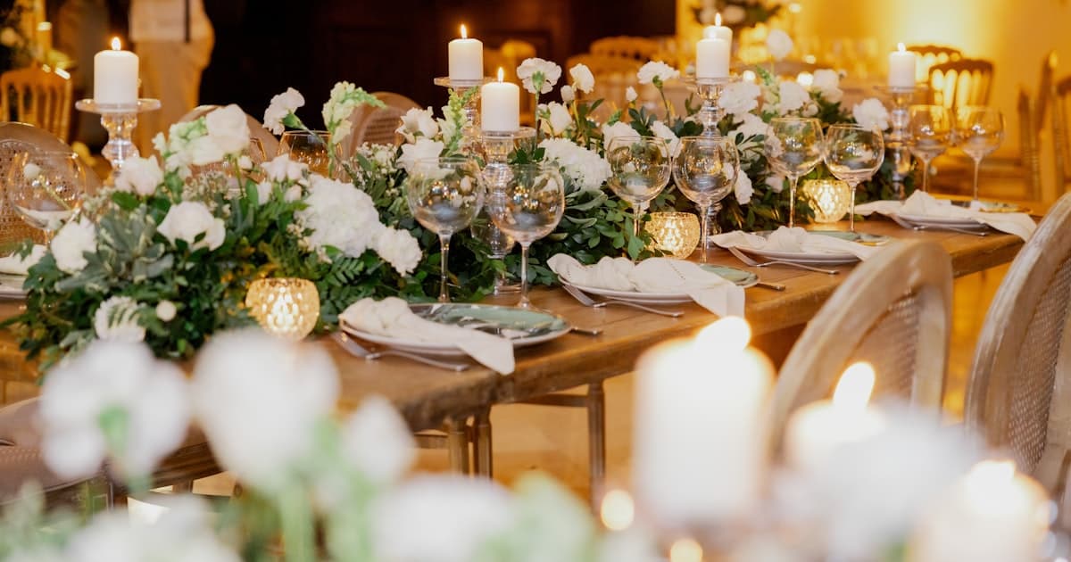Elegant rehearsal dinner table setting with candles and flowers for digital rehearsal dinner invitations