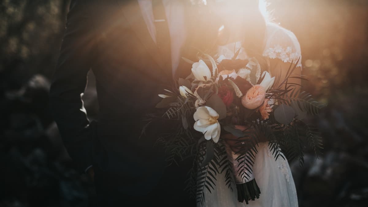 Wedding rings and planning details — preparing to send save the date via WhatsApp broadcast