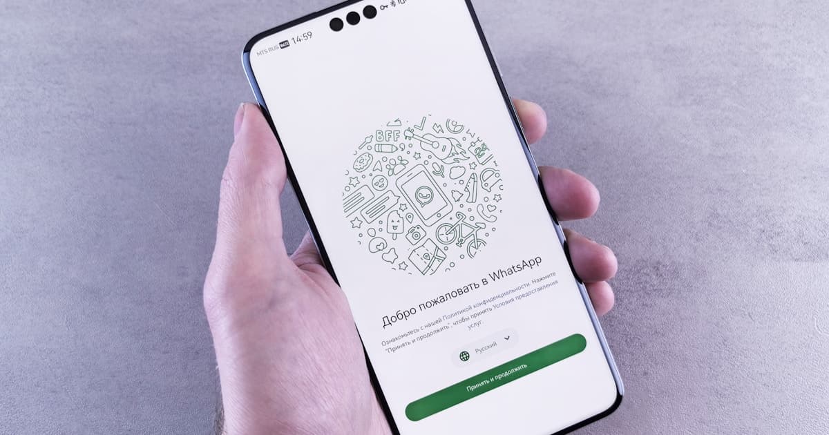 Hand holding smartphone with WhatsApp screen — save the date via WhatsApp guide
