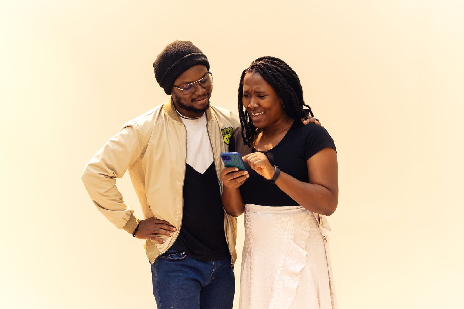 Couple sharing a digital wedding invitation on smartphone — how to send digital wedding invitations via text, email, and WhatsApp