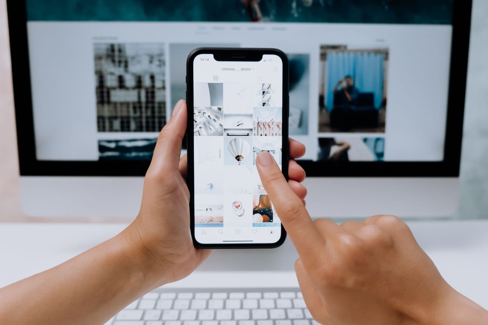 Hands holding a phone while comparing Vow Invites vs NIMNTRN digital wedding invite links