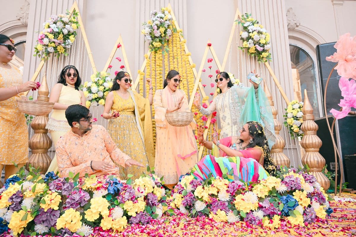 Colorful Indian wedding ceremony with guests and floral decorations