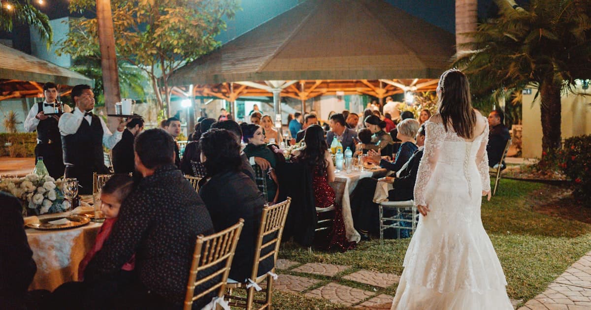 Outdoor wedding weekend itinerary invitation reception with guests seated at decorated tables