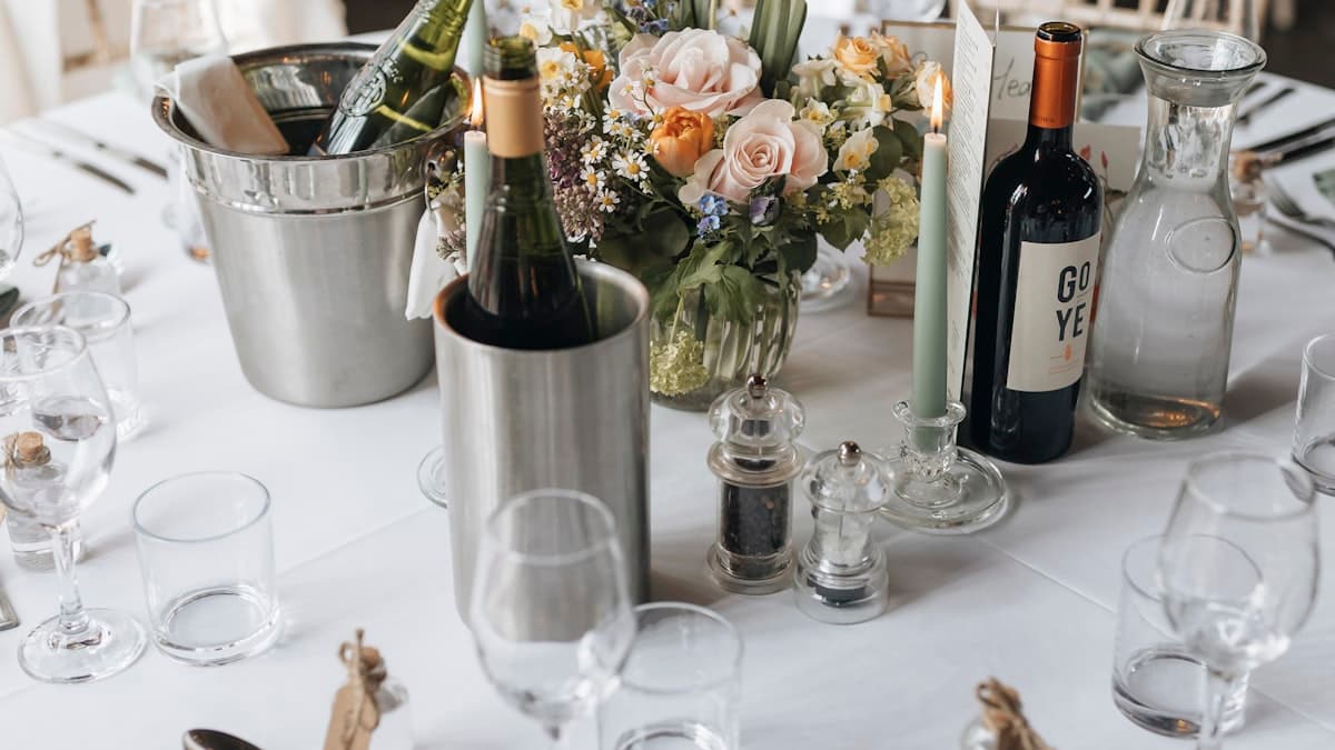 Beautifully set wedding weekend itinerary invitation reception table with floral arrangements