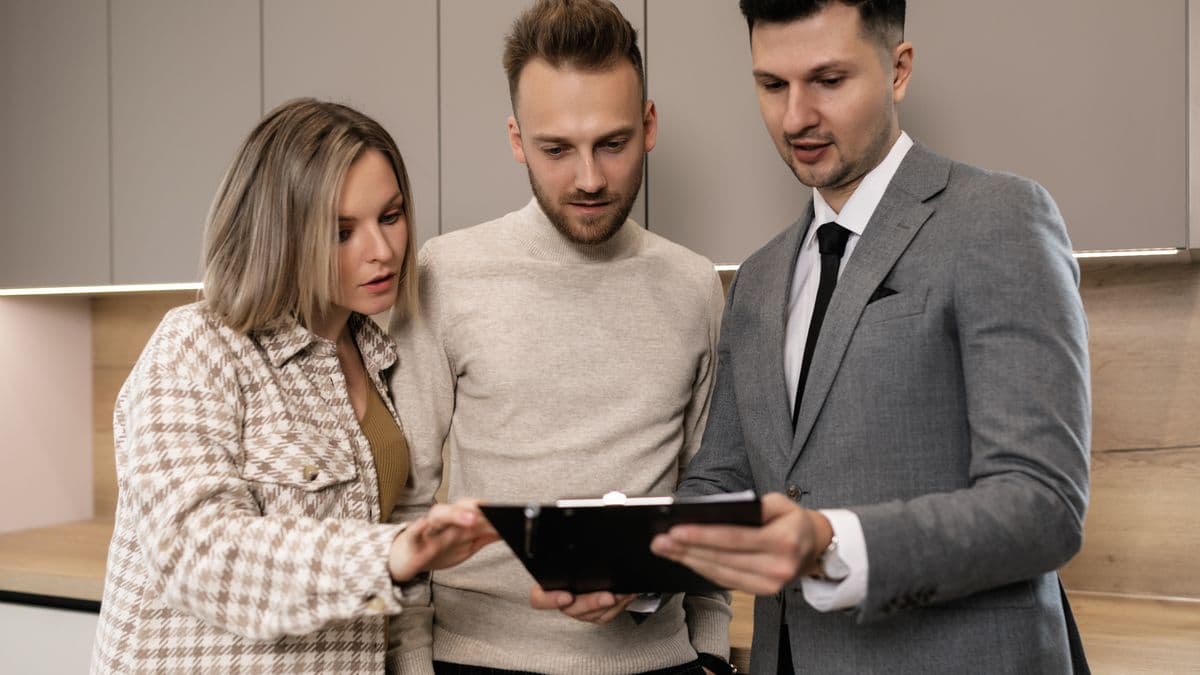 Couple reviewing wedding planning documents together to compare RSVP tracking methods