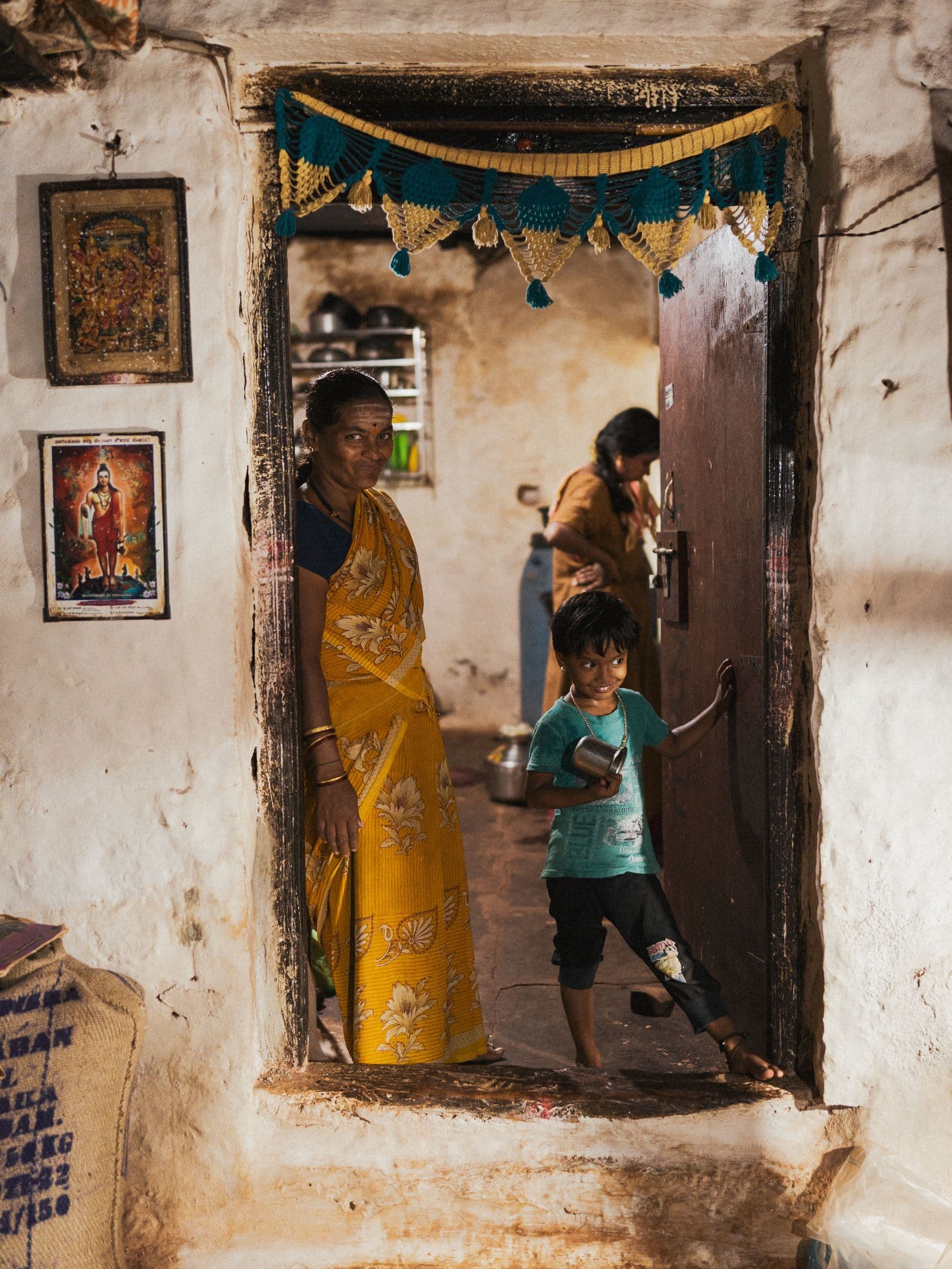 Indian family at a home entrance for a griha pravesh invitation online