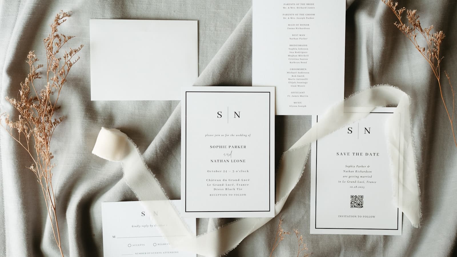 Wedding invitation suite on a bed, illustrating the stationery look behind Paperless Post pricing