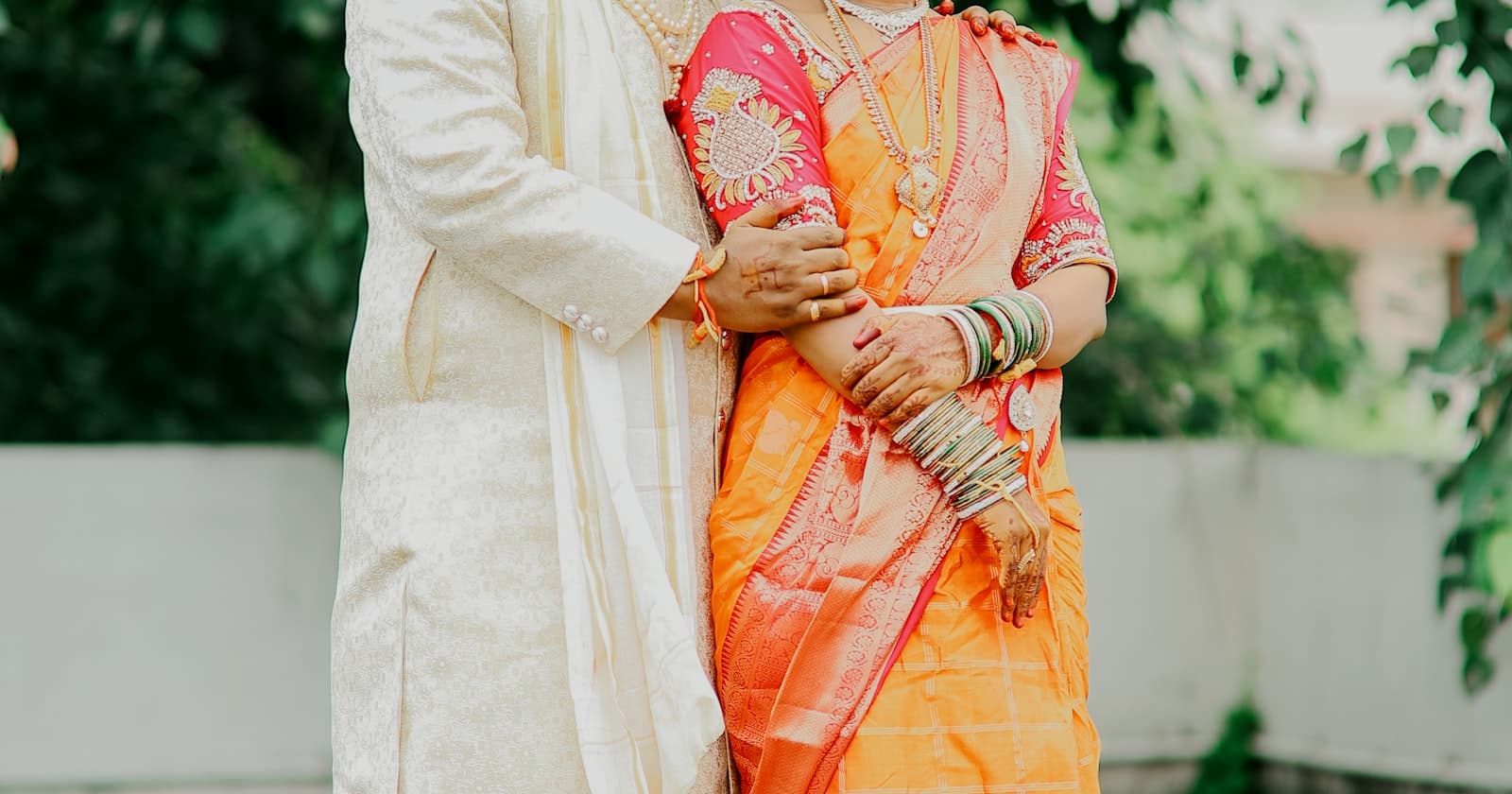 South Indian wedding couple in silk saree and sherwani for a south indian wedding invitation digital guide