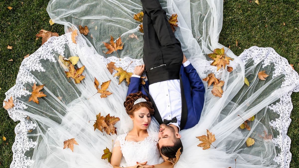 Couple comparing The Knot vs Zola online invitations on a laptop while planning their wedding