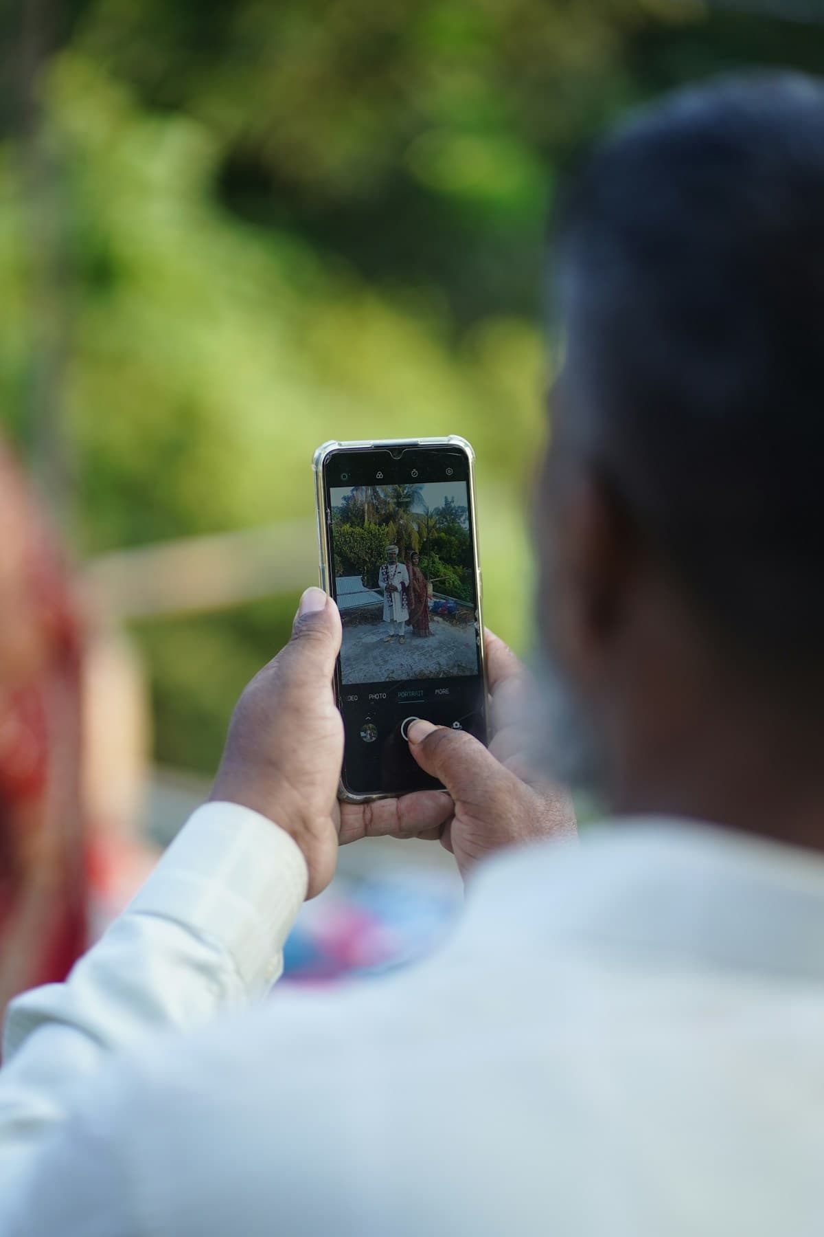 Indian wedding couple with smartphone — wedding invitation website India comparison